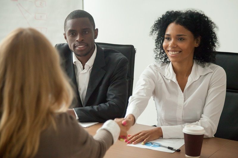 African american hr team welcoming female applicant at job interview cm