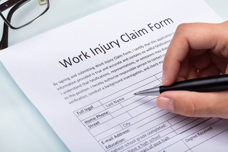 Woman Filling Work Injury Claim Form cm