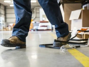 An industrial safety topic. A worker tripping over a trash on a factory floor cm 440x293 350x263